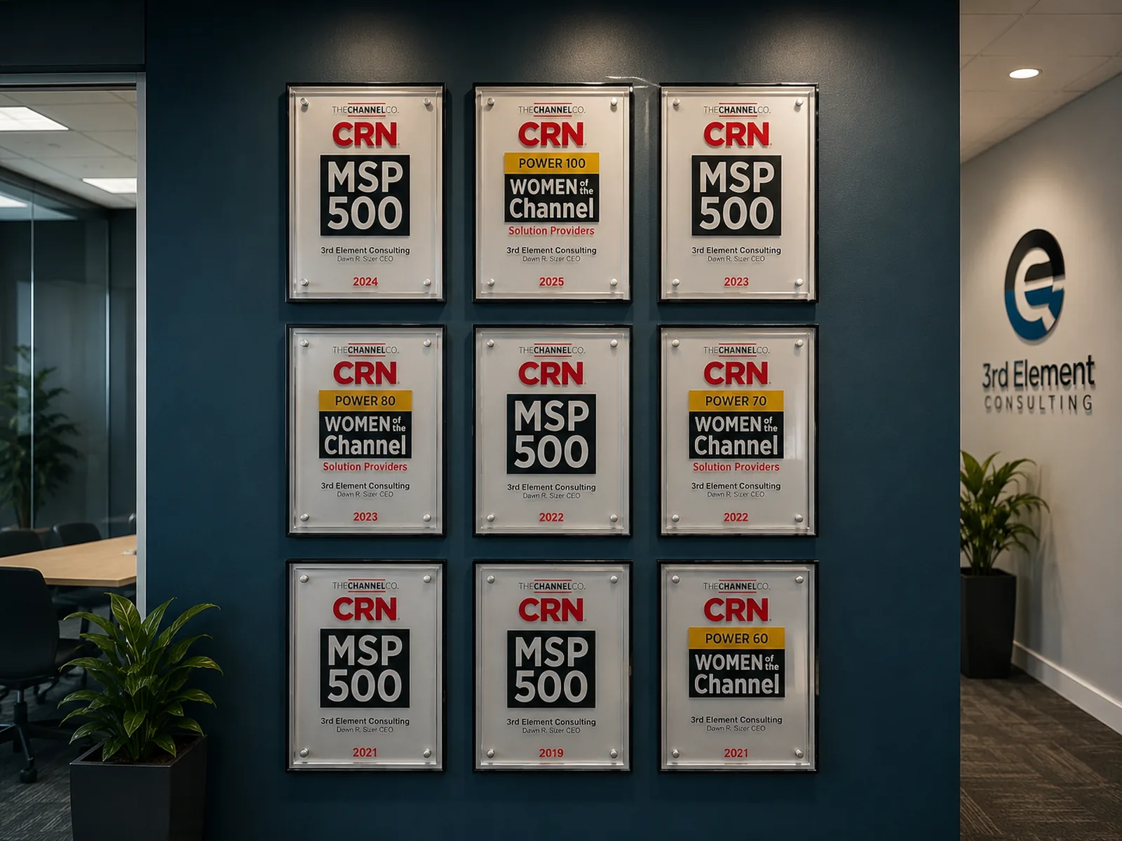 Wall of framed CRN MSP 500 and Women of the Channel awards at the 3rd Element office.