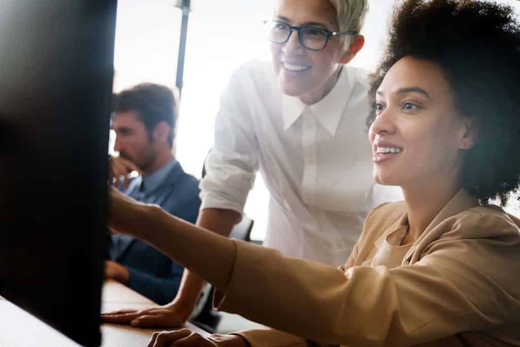 two woman collaborating on IT project