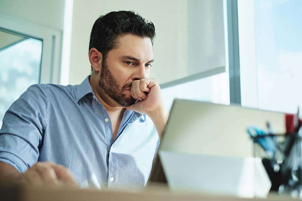 man focused working on laptop